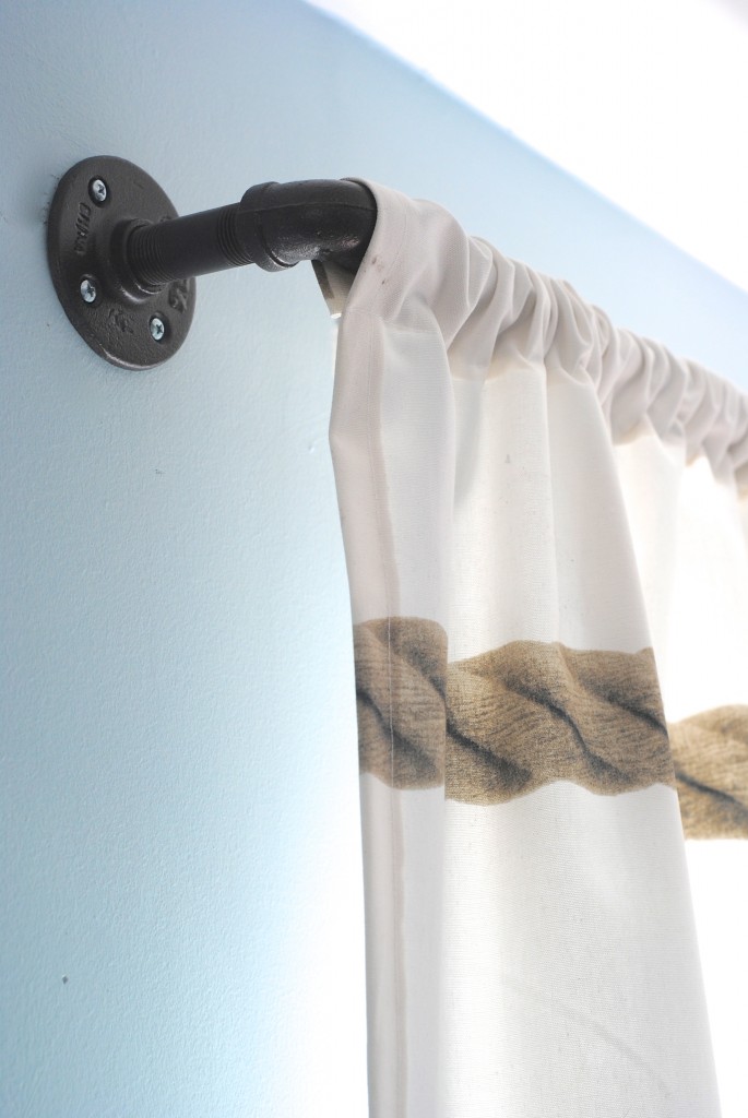 These DIY industrial style pipe curtain rods are a cinch to make, and way cheaper than the West Elm version. Get the tutorial at www.makinglemonadeblog.com! #DIY #knockoff #curtains