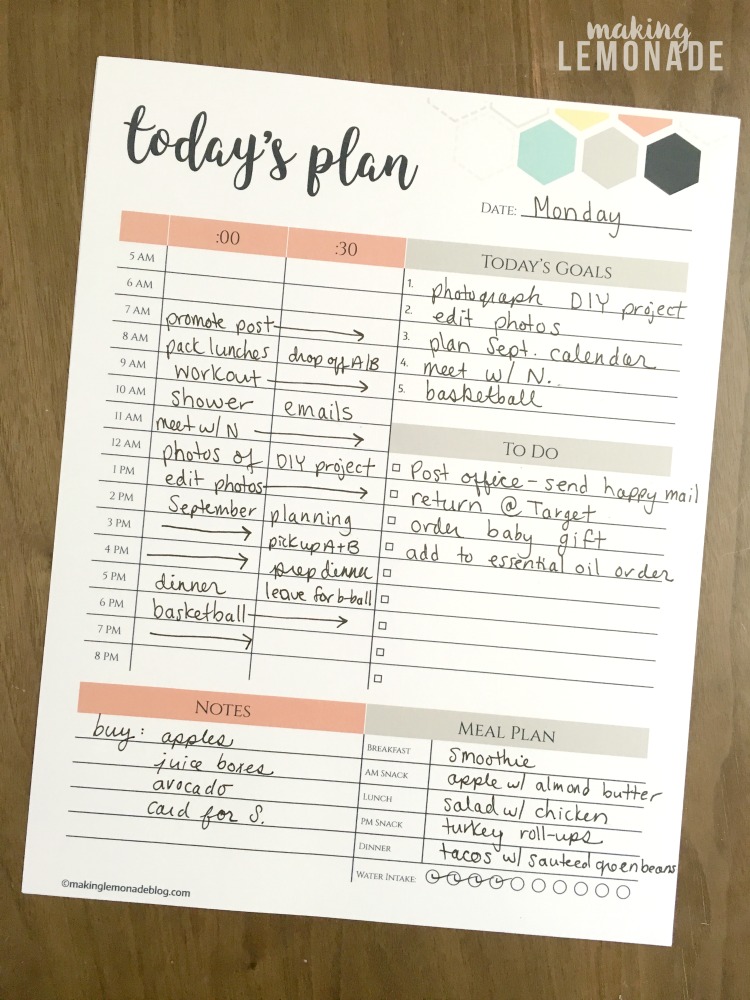 Printable daily planner filled in on wooden counter