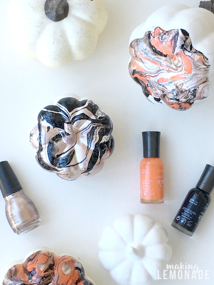 I had no idea you could use nail polish to marbleize ANYTHING, like these marbled pumpkins for glam Halloween and fall decor