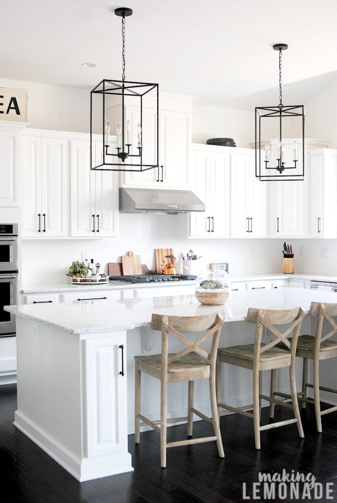 Quick and easy way to update your kitchen cabinets! (lots of decor ideas in this white farmhouse style kitchen, YES to the quartz countertops as an alternative to marble too!)