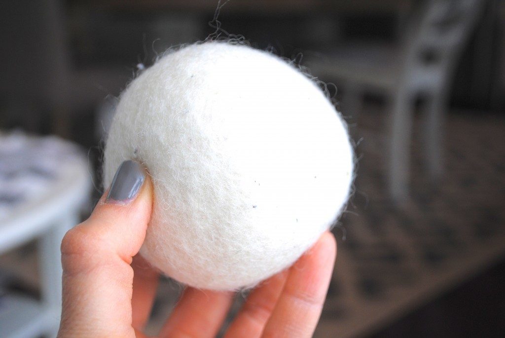 woman holding a wool dryer ball