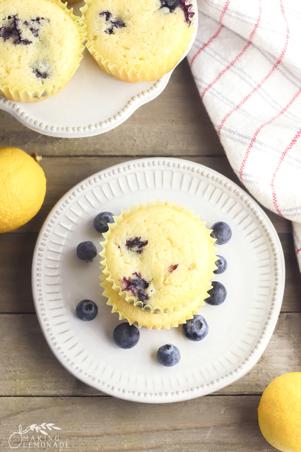 muffins surrounded by blueberries and a lemon