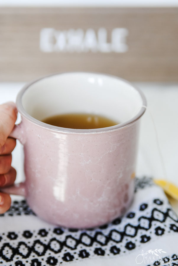 mug of tea with hand