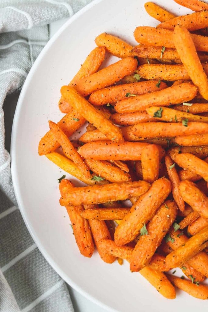 baby carrots in a white serving bowl
