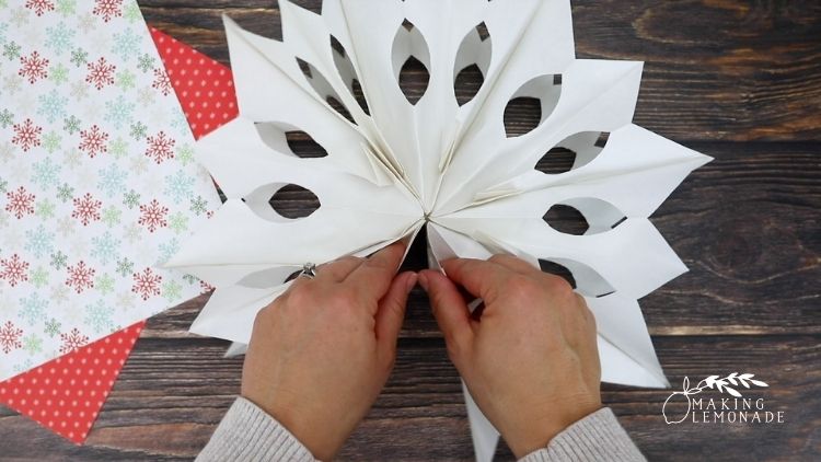 Unfolding a 3D paper bag snowflake craft
