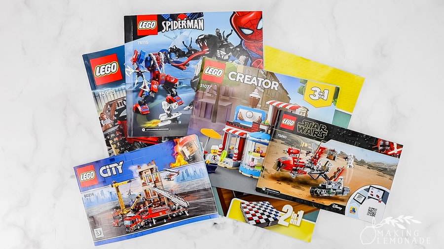pile of LEGO manuals