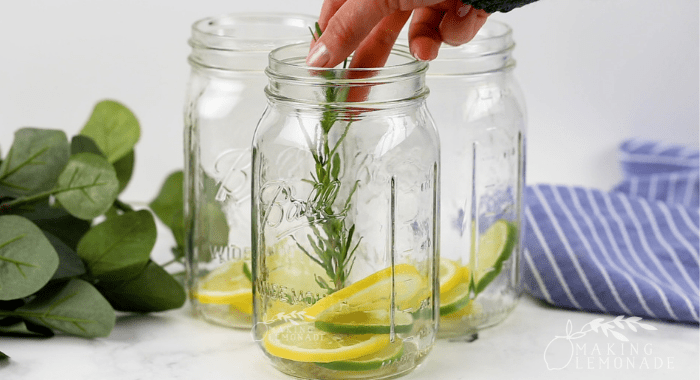 adding lemons to mason jar