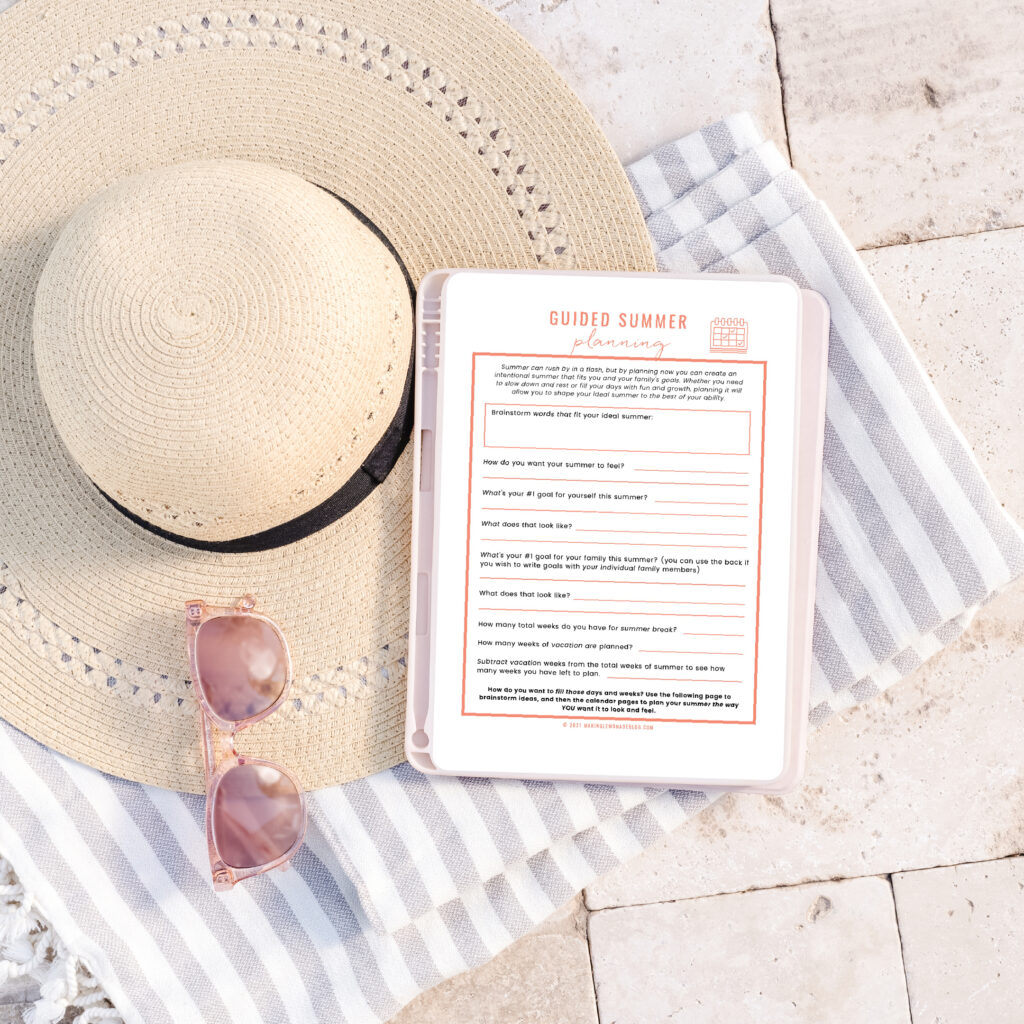 summer planner on ipad with beach hat and pool towel