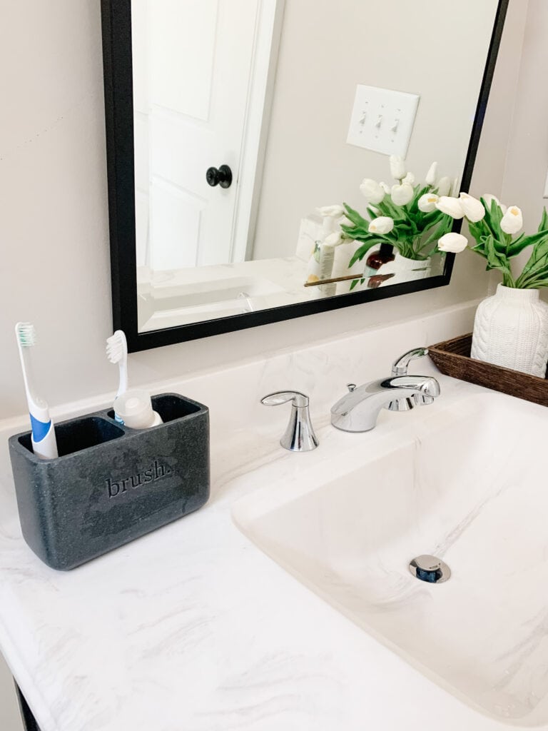 bathroom vanity with toothbrushes