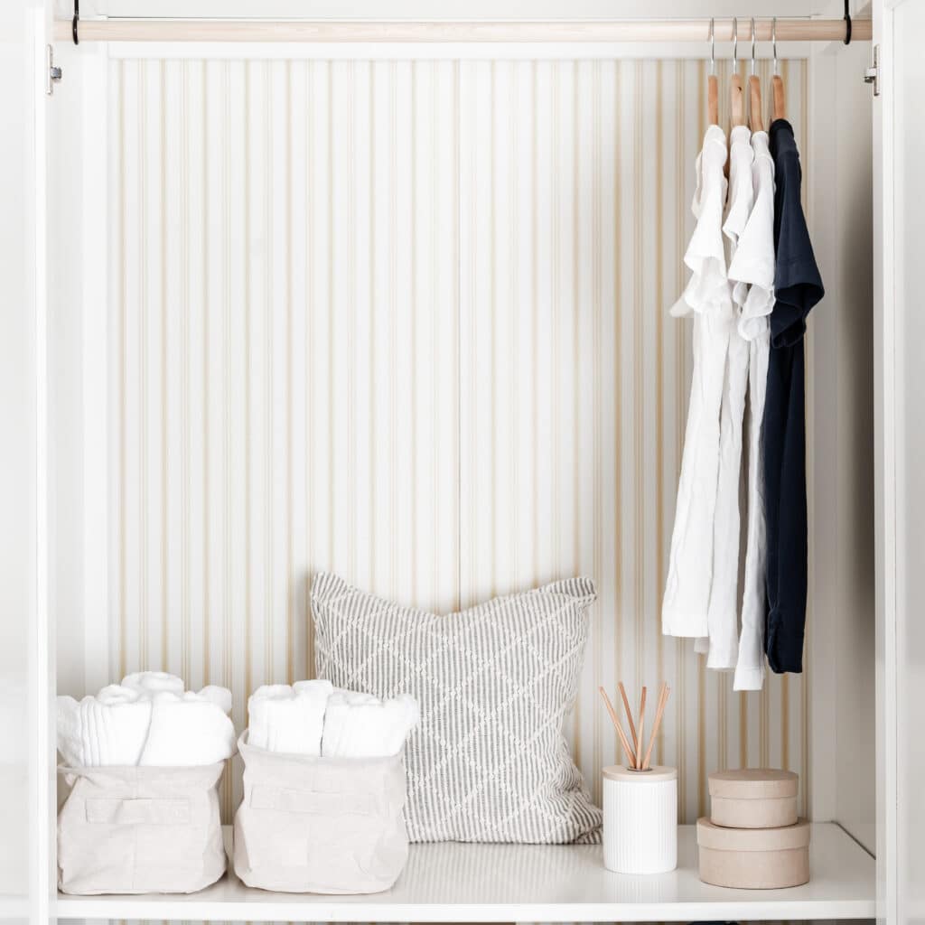 tidy and organized space with hanging clothes on closet rod