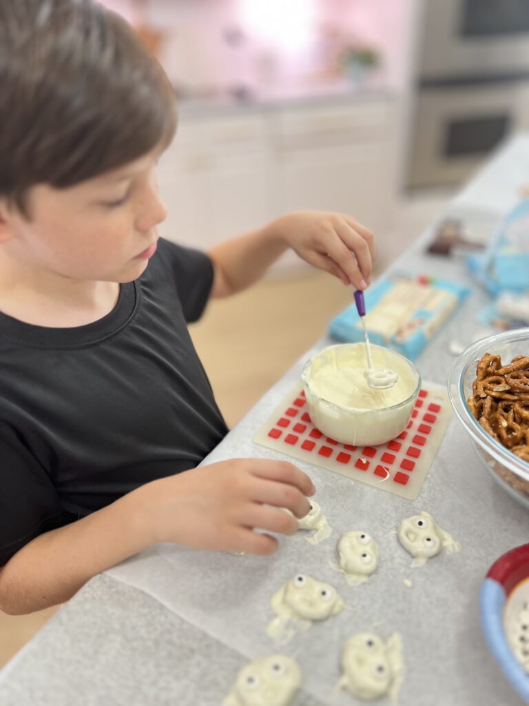 dipping chocolate covered pretzel ghosts
