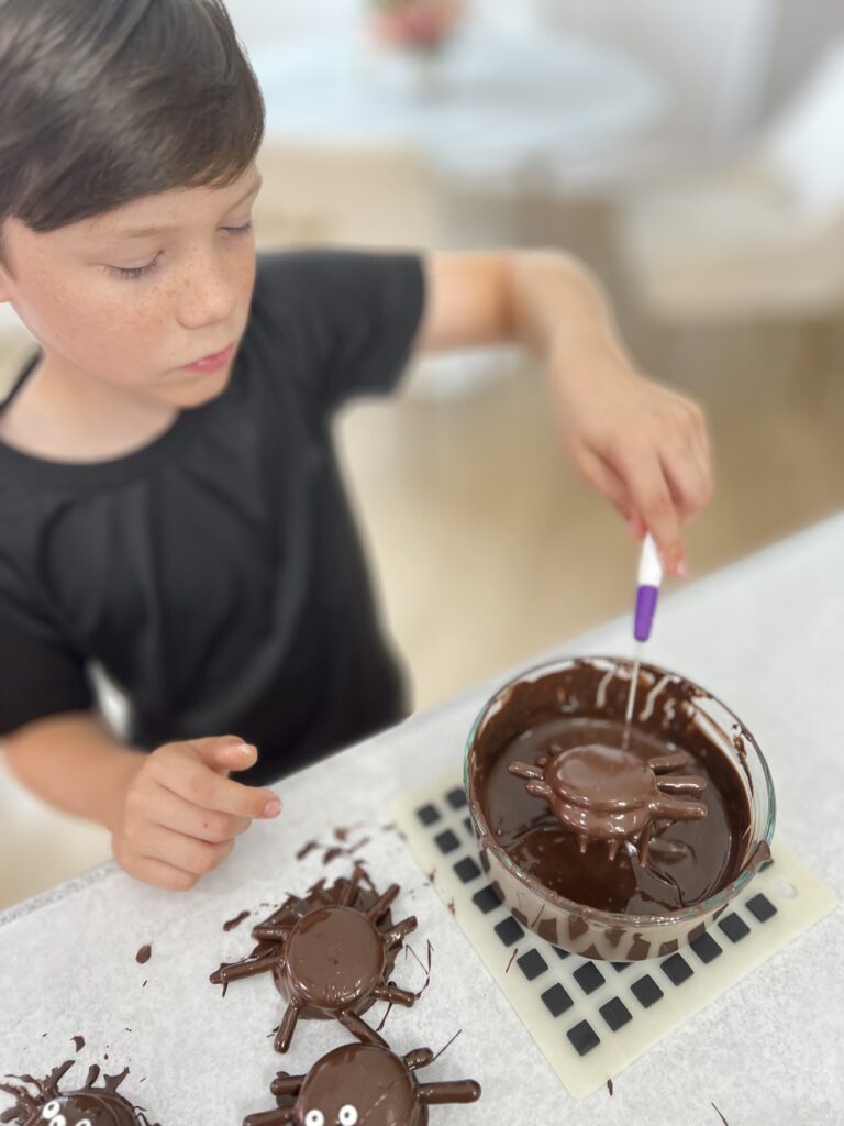 dipping the spider in the chocolate