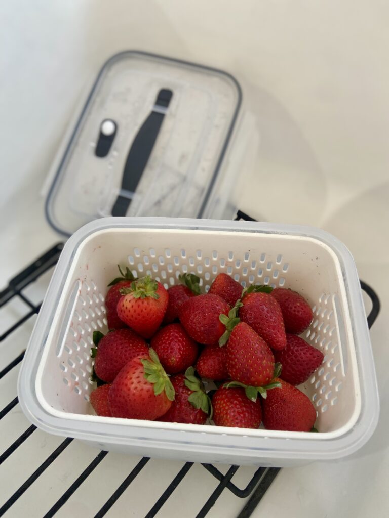 strawberries in a produce storage container