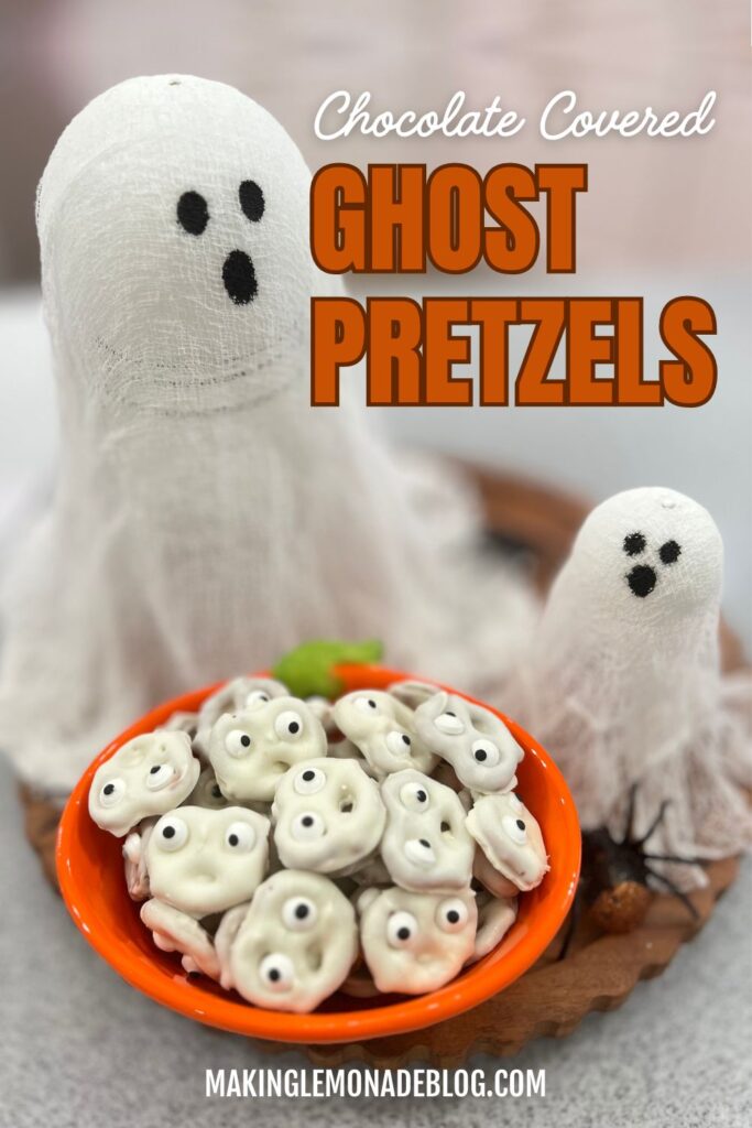 chocolate covered pretzel ghosts in a bowl and decorative ghosts