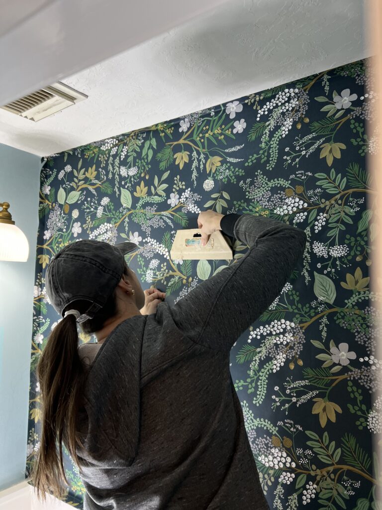 smoothing the peel-and-stick wallpaper 