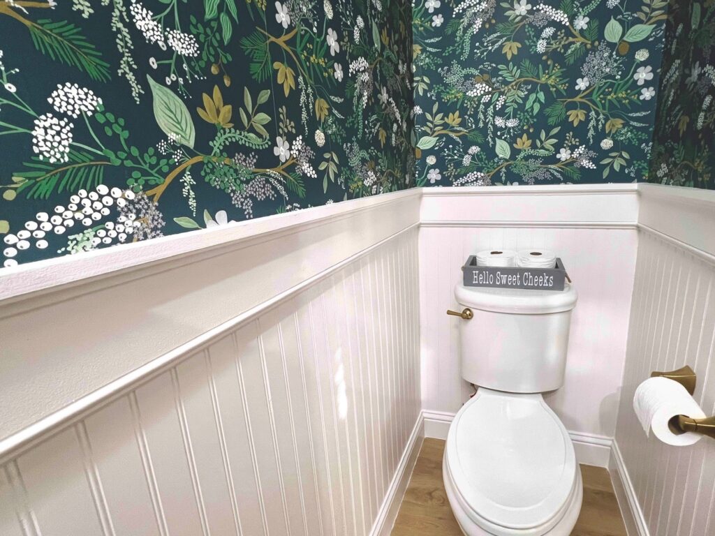 finished look of half bathroom with beadboard paneling and peel-and-stick wallpaper Rifle Paper Co Juniper Forest 