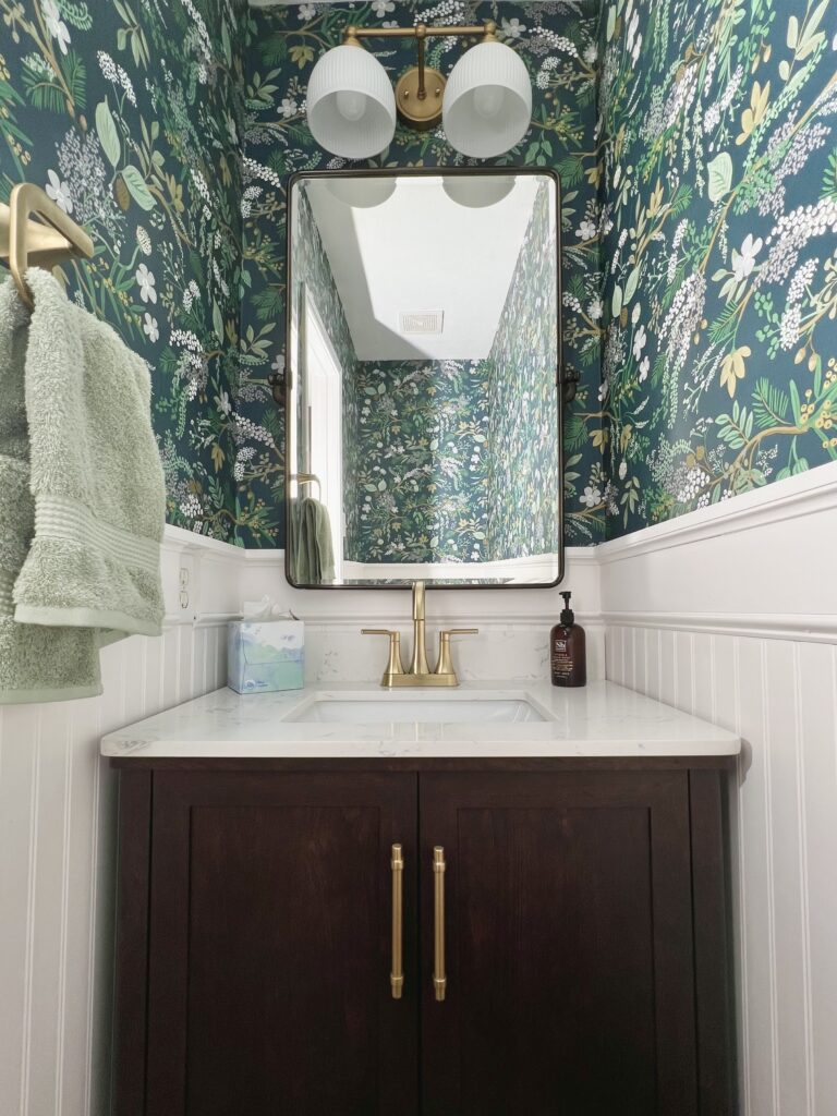 Home Depot vanity and Rifle Paper Co wallpaper in half bathroom 