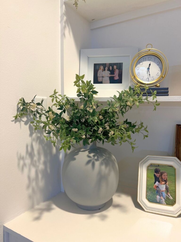 monobotanical faux greenery and floral arrangement on shelf