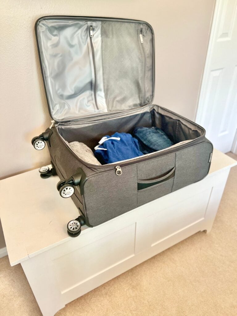 blanket chest that doubles as a suitcase stand in the guest room 