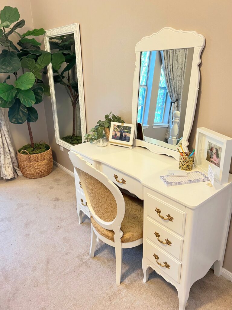 vanity with mirror and full length mirror in guest bedroom 