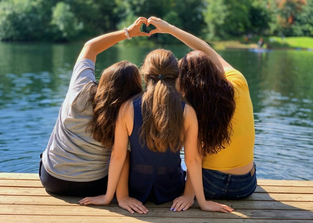 girls at summer camp with heart hands