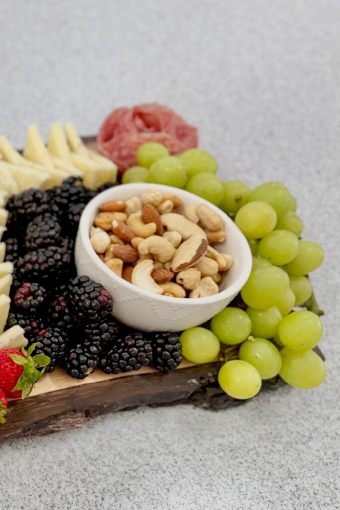 charcuterie board with ramekin of nuts