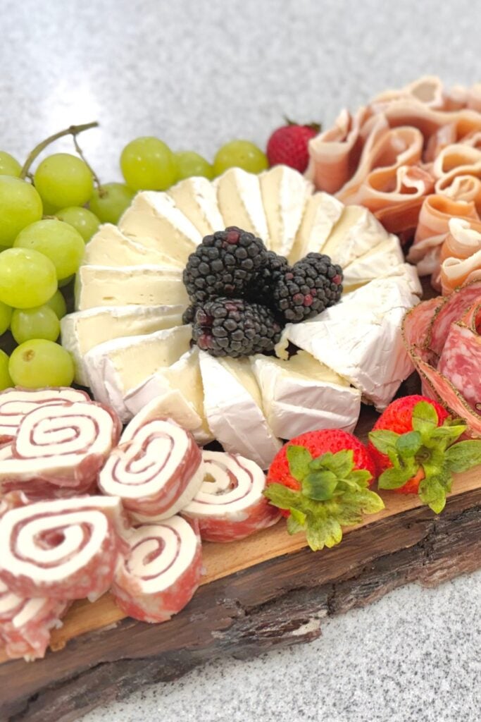 brie with blackberries on a charcuterie board